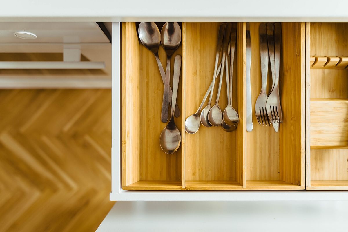 An overhead view of a cutlery drawer with bamboo dividers